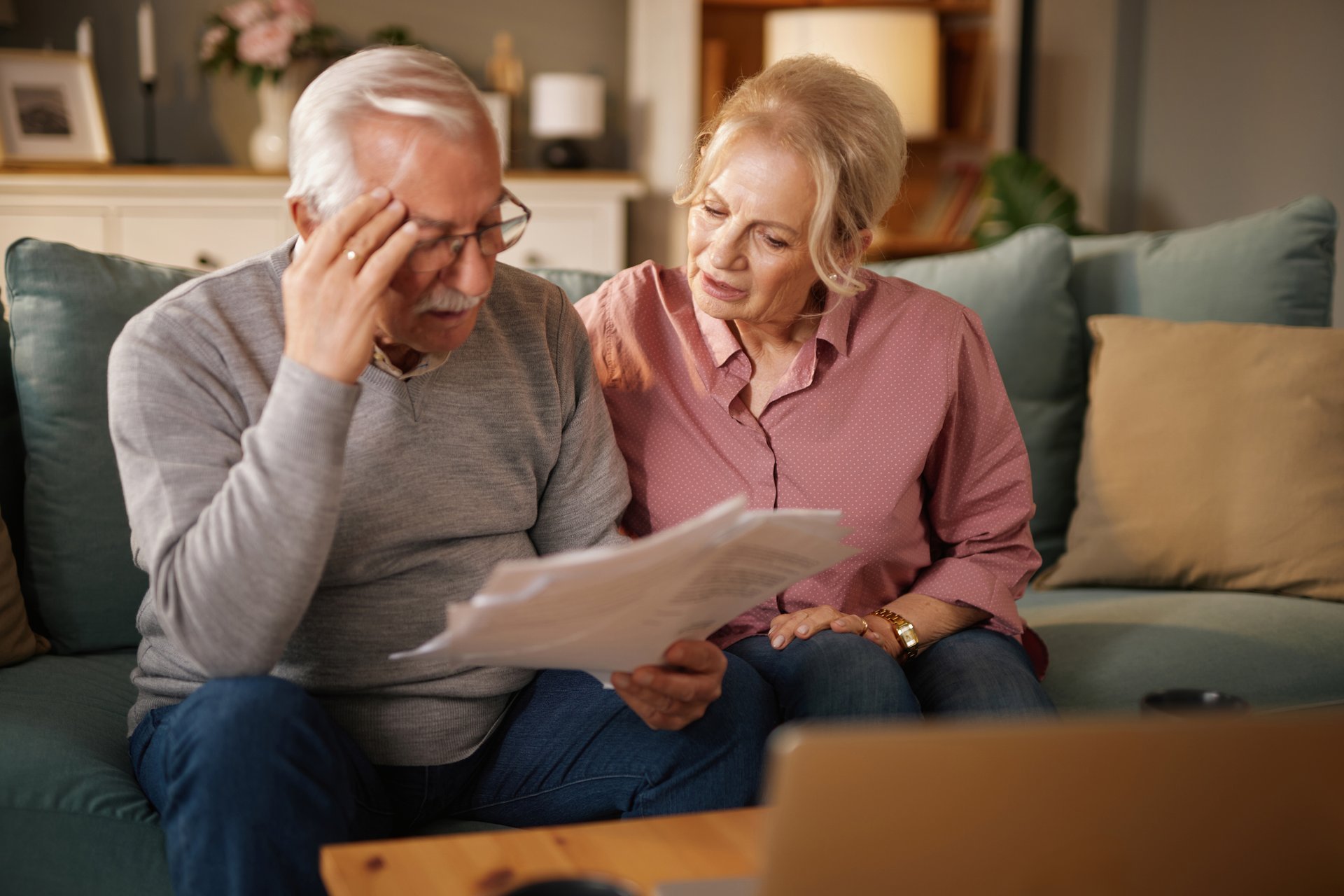 Senior couple looking concerned about medical bills